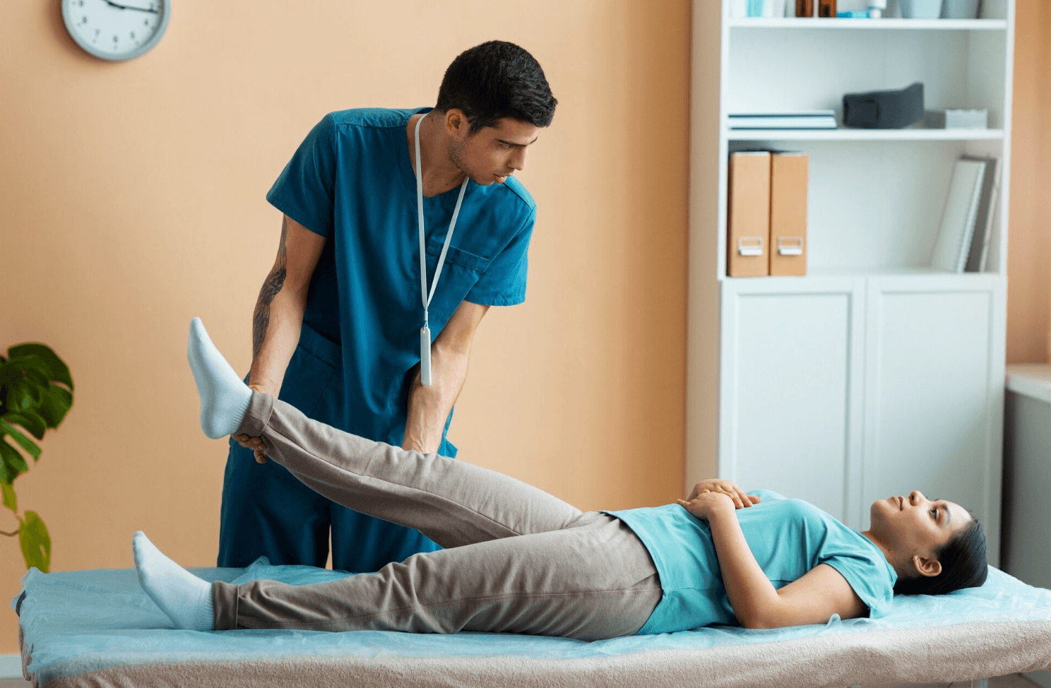 A physiotherapist is helping a patient.